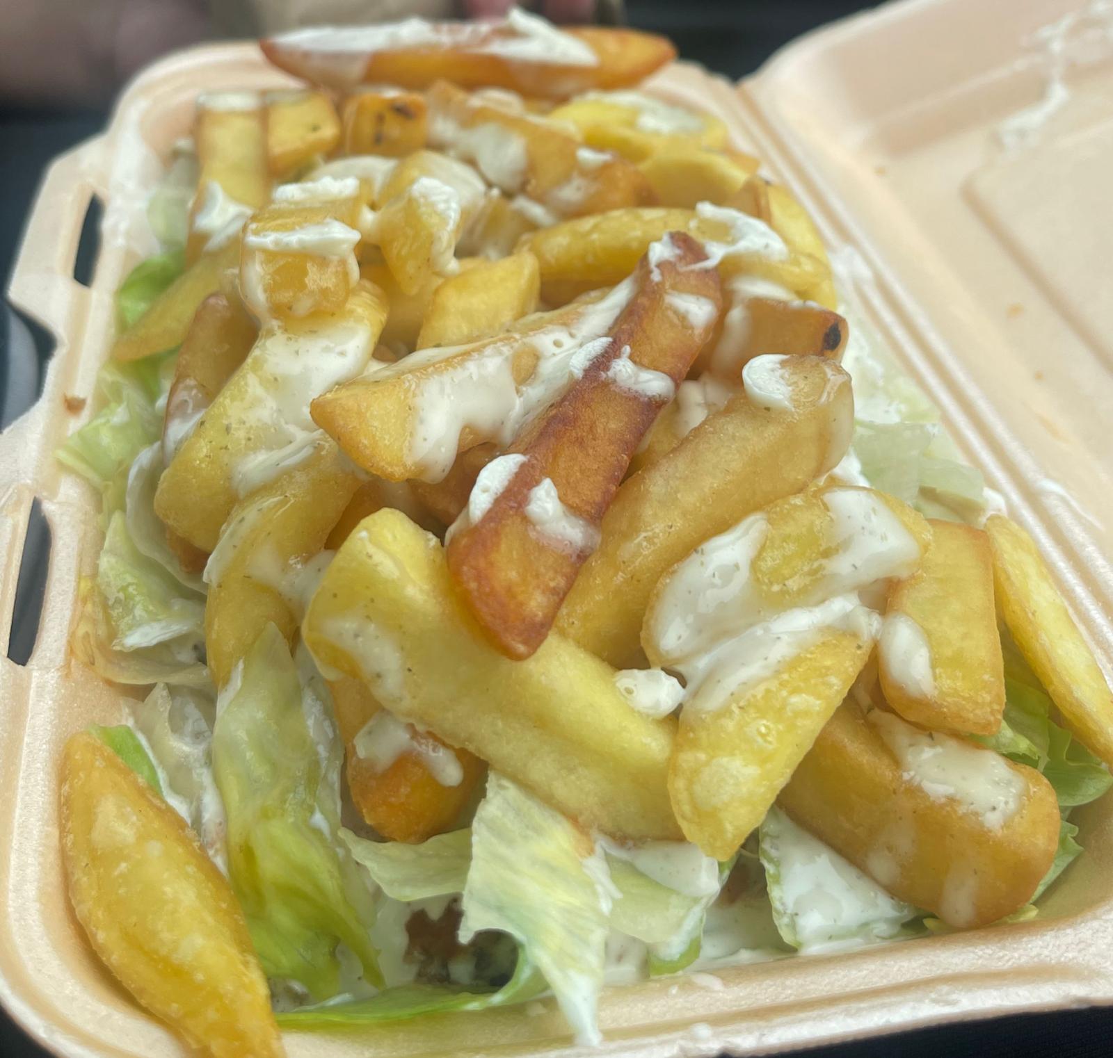 Loaded chips with salad and garlic sauce